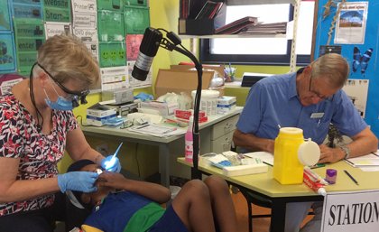 A young boy receives preventative oral dental treatments